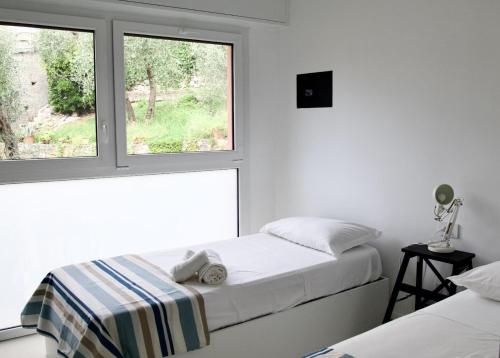 a bedroom with two beds and a window at Tigullio Blue Experience - Portofino Luxury View in Villa Solari