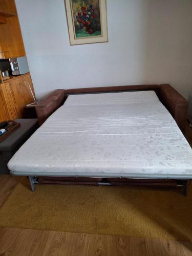 Ce lit se trouve dans un dortoir doté d'un matelas blanc. dans l'établissement La Foux d'Allos joli studio familial 2-4 pers, ski et randonnées, à Allos