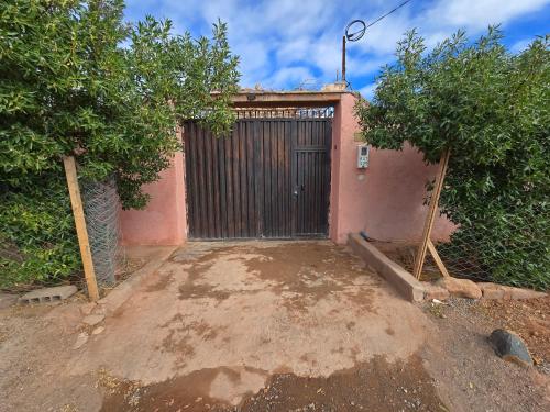 a gate to a house with trees in front of it at Villa Privée 2 Marrakech Piscine Chauffée En Option sans vis à vis pour famille et couple marié uniquement in Marrakech