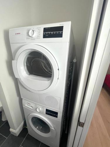 a washer and dryer sitting in a room at Retro Baseball Downtown Apartment in Saint Louis
