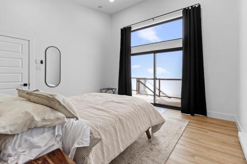 a bedroom with a bed and a large window at Flatrock Ocean View Sauna 3B 35BA in Flat Rock