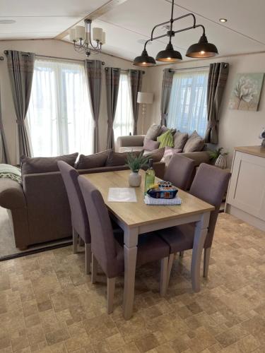 a living room with a table and a couch at Summer Days at Seven Bays Padstow in Padstow