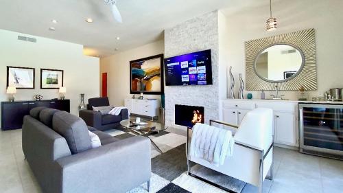 a living room with a couch and a fireplace at Splash Pad in Rancho Mirage