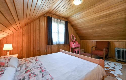 a bedroom with a large bed in a wooden room at Stunning Home In Veliko Trgovisce in Veliko Trgovišće