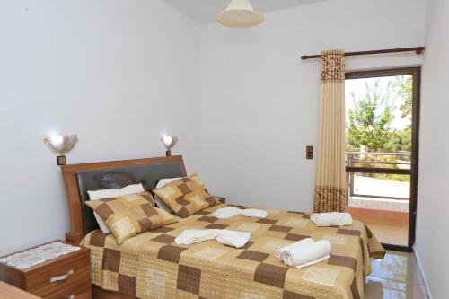 a bedroom with a bed with two towels on it at Maria Apartments in Hersonissos