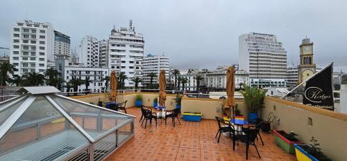 a balcony with tables and chairs on a building at Ryad 91 in Casablanca
