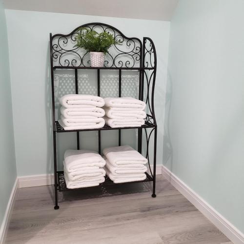 a black towel rack with white towels on it at DayDreamer Beachfront w 7 Bedrooms in Gilchrist