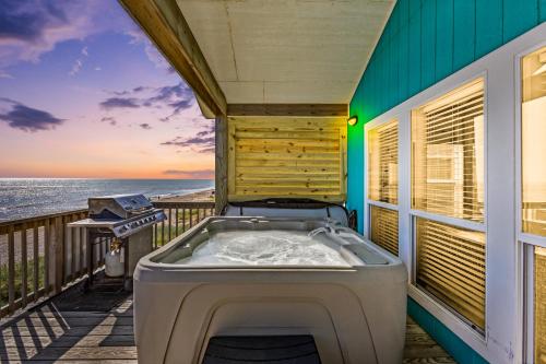 a hot tub on the balcony of a house at MoonStone 3BR Beachfront w Hot Tub Amazing Beach Views and Large Deck in Gilchrist