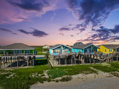 a row of houses on a dock on the beach at MoonStone 3BR Beachfront w Hot Tub Amazing Beach Views and Large Deck in Gilchrist