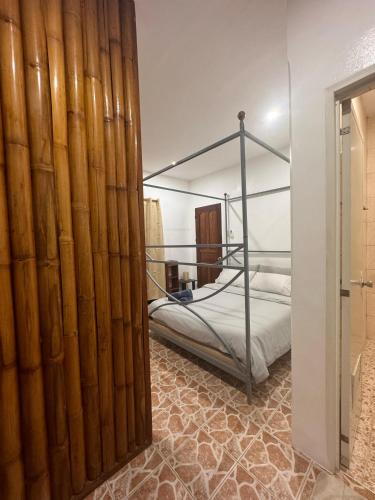 a bedroom with a bed with a metal canopy at Stay Inn 3 Boracay in Boracay