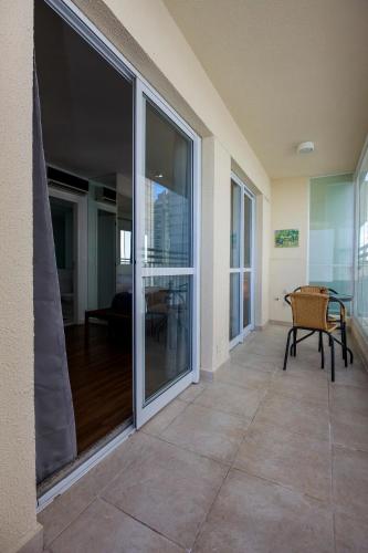 a balcony with sliding glass doors in a house at Cobertura Penthouse no Alto da Boa Vista - Santo Amaro in Sao Paulo