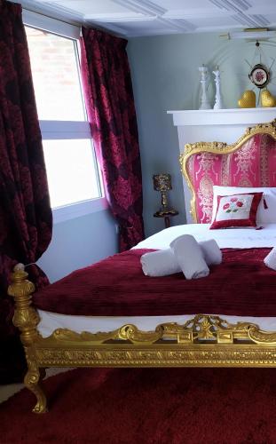 a bedroom with a bed with a gold frame and a window at Διώροφο πέτρινο σπίτι με θέα Agiasos Classic Stone House in Agiásos
