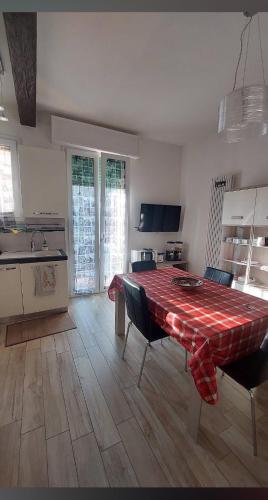 a kitchen with a table with a red table cloth on it at Cà di Reno in Casalecchio di Reno