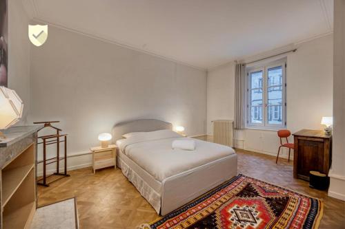 a white bedroom with a bed and a dresser at Bedroom 1 - Elegance & Comfort - COLIVING Historic House in Ferney-Voltaire