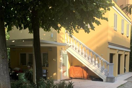 a house with a staircase with an orange sheet on it at La tua casa con giardino a 2 passi dal centro in Modena