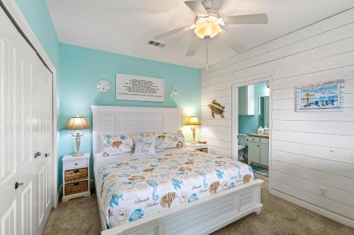 a bedroom with a bed and a ceiling fan at Sconset South 4BR Beach Escape! Deck, Bar, Games & Gulf Views in Port Bolivar