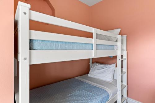 a bunk bed room with two bunk beds at Sconset South 4BR Beach Escape! Deck, Bar, Games & Gulf Views in Port Bolivar