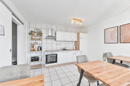 a kitchen with a table and a dining room at Atelier Guesthouse in Filderstadt
