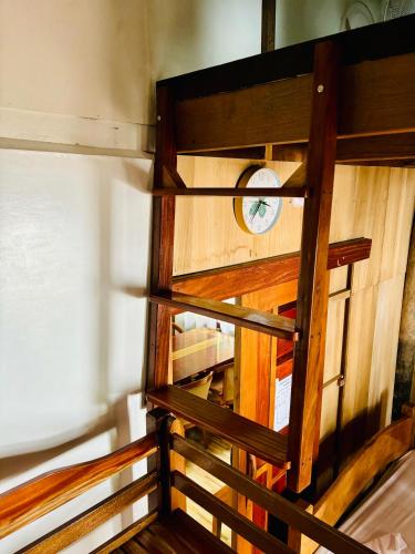 an overhead view of a wooden staircase with a clock at Beachfront Cabin in Lobo in Batangas City