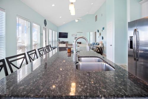 a kitchen with a sink and a counter top at Splash Spacious 3BD 3bath Beachfront! Steps to Beach! in Gilchrist