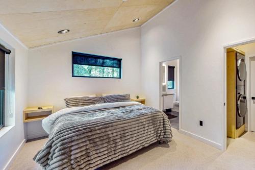 a bedroom with a bed and a window at Timbers & Tides in Shelton