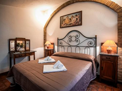 a bedroom with a bed with two towels on it at Casale Colle dell'Asino in Ciampino