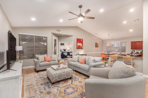 a living room with two couches and a kitchen at Awesome Chandler Home with Heated Pool Dog Friendly 2966 in Chandler