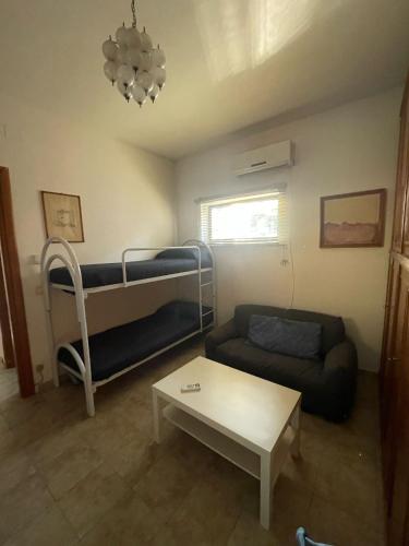 a living room with a couch and a bunk bed at Anna e Gaetano in Misterbianco