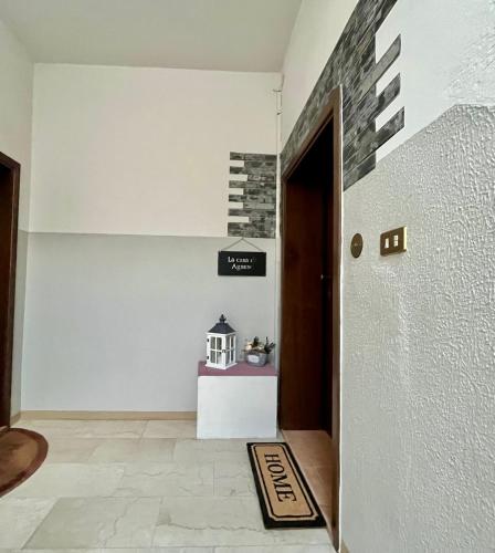 a hallway with a door and a sign on the wall at La Casa di Agnese in San Benedetto Val di Sambro
