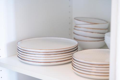 a stack of plates sitting on a shelf at Atelier Guesthouse in Filderstadt