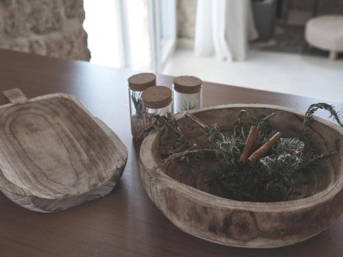 a wooden bowl sitting on top of a table at Astarte Villas - Arismari Villa K1 in Vasilikos