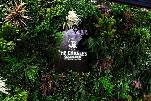 a wall of plants with a sign on it at Tree House - Luxury Riverside Escape! in Bedford