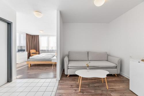 a living room with a couch and a table at Atelier Guesthouse in Filderstadt