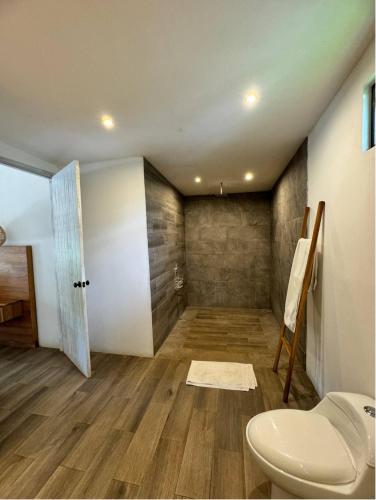 an attic bathroom with a toilet and a door at Santuario in Paraíso