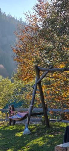 a wooden fence with a broom on it in the grass at Vikendica GORSKI VUK Jelovica in Berane