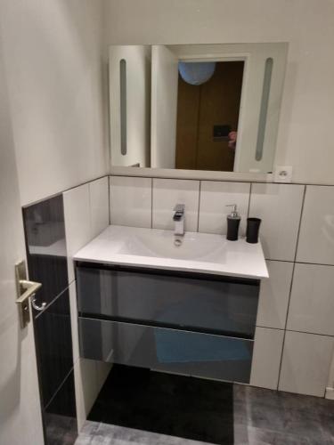 une salle de bain avec un lavabo et un miroir dans l'établissement Joli appartement en résidence avec piscine et gardien, à Mandelieu-la-Napoule