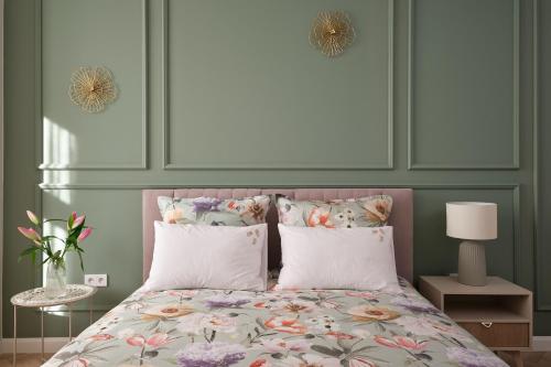 a bedroom with a bed with a headboard and pillows at Apartamenty Centrum Sobieski in Wałbrzych