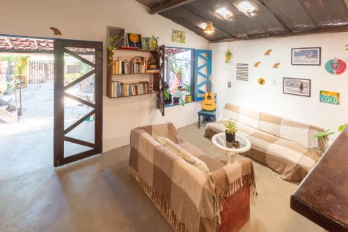 a living room with a couch and a table at Pipa Surf House in Pipa
