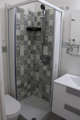 a bathroom with a shower with a toilet and a sink at Gelsomino I in Ustica