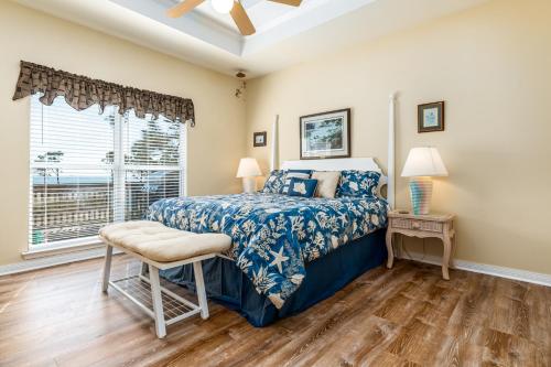 a bedroom with a bed and a window at Tan Lines in Dauphin Island