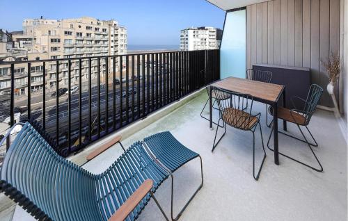 a balcony with a table and chairs on a balcony at Amazing Apartment In Oostende in Ostend