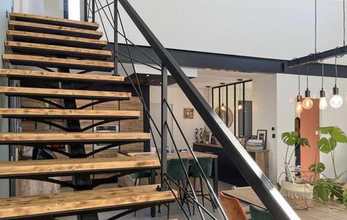 a staircase in a room with a table and a stair case at Pet Friendly Home In Valaurie With Wifi in Valaurie