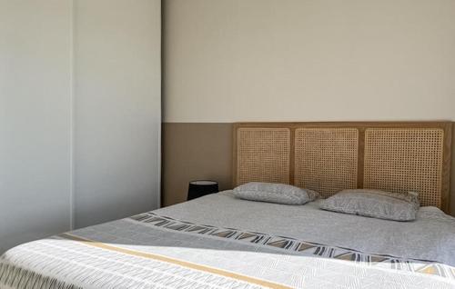 a bedroom with a bed with two pillows on it at Pet Friendly Home In Valaurie With Wifi in Valaurie