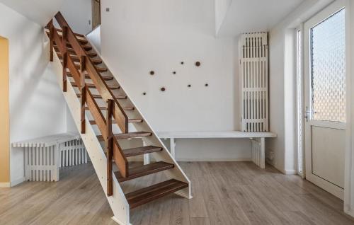 a wooden staircase in a room with a wall at 3 Bedroom Lovely Home In Thisted in Thisted