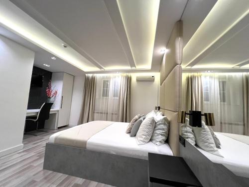 a bedroom with two beds and a piano at Hotel Forever in Belgrade