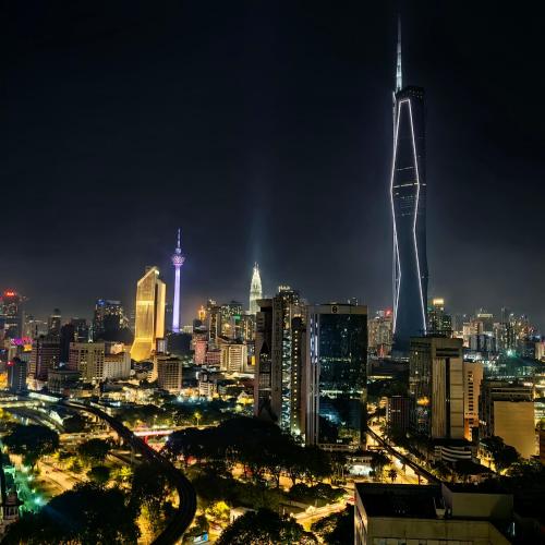 a city skyline at night with a tall skyscraper at KL Sentral Dua Sentral Cozy Homestay Apartments by Hollywood Homes #FreeCarPark in Kuala Lumpur
