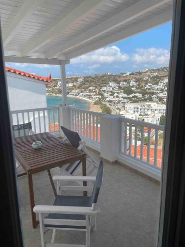 a balcony with a table and chairs and a view of the ocean at Relax with a view in Batsi