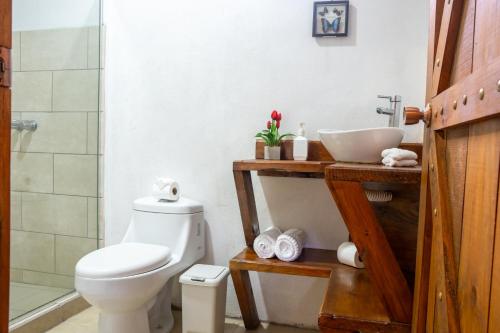 a bathroom with a toilet and a sink at Tierra Buena Countryside Hotel in Monteverde Costa Rica