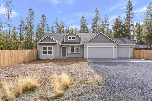 a house with a garage and a fence at Four Seasons Retreat in Bend