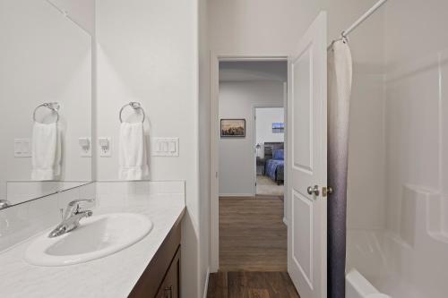 a white bathroom with a sink and a shower at Four Seasons Retreat in Bend